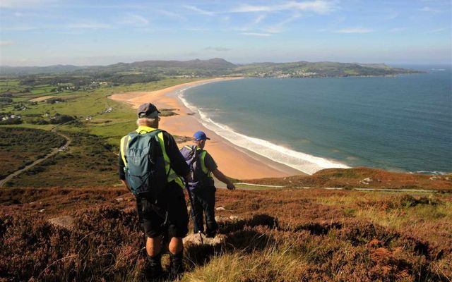 Walkers on the Donegal Camino make their way down Knockalla toward Ballymastocker Bay. 