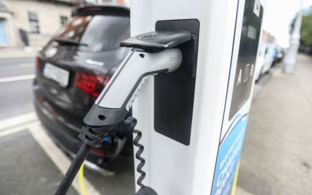 An electric car charging at an EV port.