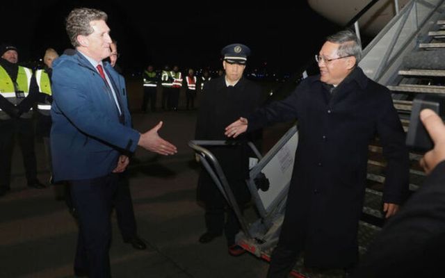 Minister for the Environment Eamon Ryan greets Li Qiang, Premier of the People\'s Republic of China, on the runway at Dublin Airport as he arrives for his visit to Ireland.