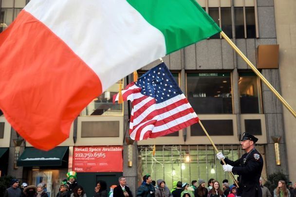 March 17, 2017: Members of the New York Department of Corrections hold American and Irish flags as they march during the annual St. Patrick\'s Day parade on 5th Avenue, in New York City. 