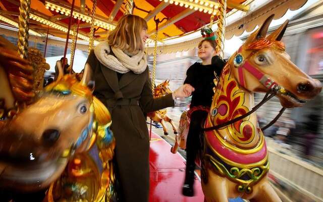 A family enjoy the carousel during the Christmas at the Castle event at Dublin Castle, Dublin.