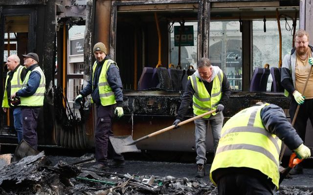 November 24, 2023: Clean-up operation - a Luas was burned and damaged on O\'Connell Street in Dublin the night before during a riot.