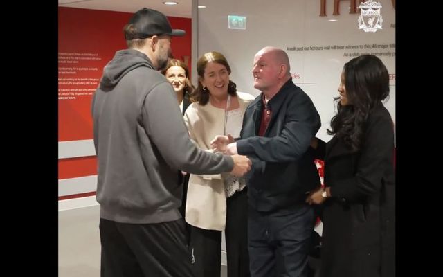 Jürgen Klopp (left) embraces Seán Cox (right) at Anfield.