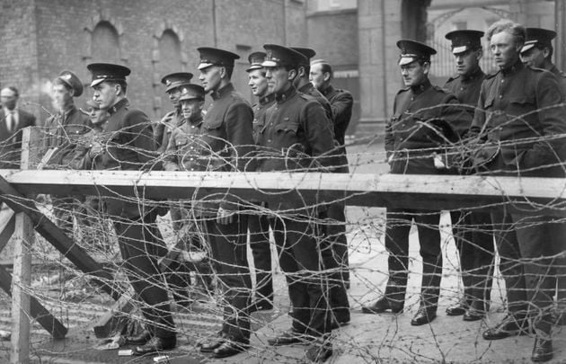 Members of the Black and Tans, an armed auxiliary force of the Royal Irish Constabulary, and British Army privates watching fighting during the siege of the Four Courts, the Dublin headquarters of the Republican forces during the Irish Civil War. 
