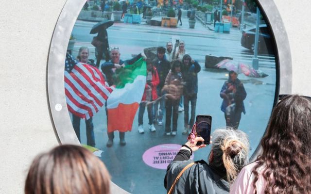 May 10, 2024: People in New York wave Irish and American flags to people in Dublin via The Portal, which was unveiled in both cities on May 8.