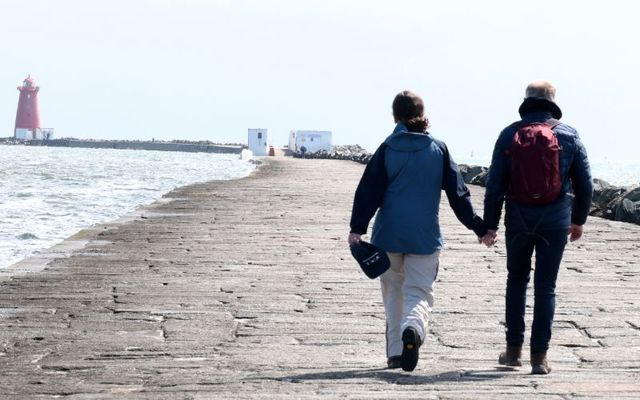 July 4, 2024: People wearing jackets while walking near Poolbeg Lighthouse in Dublin.