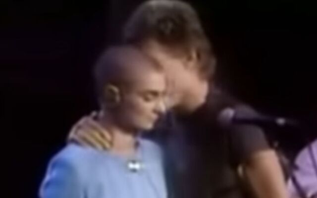 Kris Kristofferson comforts Sinéad O\'Connor on stage at Madison Square Garden as she faced booing from the crowd.
