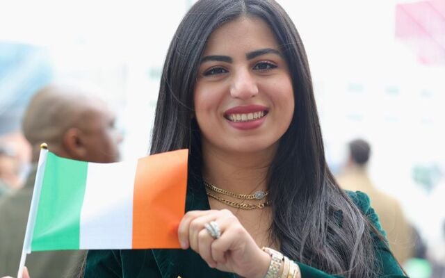 February 13, 2025: Loma Abbas from Egypt, who has been living in Ireland for almost six years, waving an Irish flag at the citizenship ceremony at the Convention Centre, Dublin.