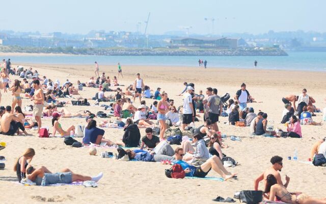 April 30, 2025: People enjoy warm sunshine on Dublin\'s Burrow Beach.