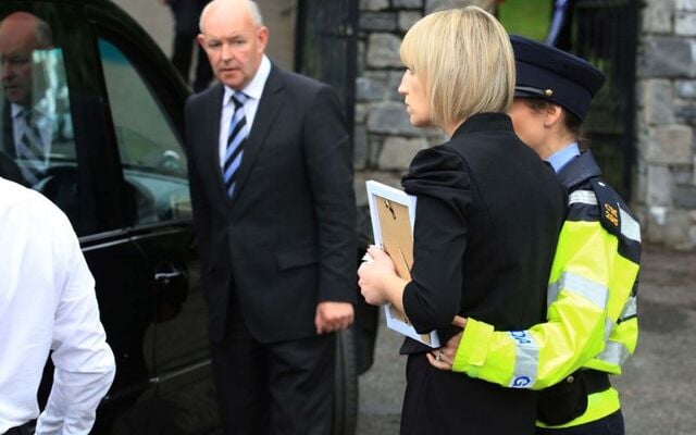 Jacqueline Connolly, sister of Clodagh Hawe is supported by a garda as she looks on as the coffin of her nephew, Liam Hawe is removed from the hearse