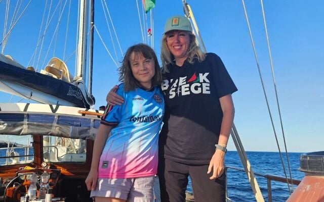 Greta Thunberg (L) donning a Bohemians FC jersey, and Caoimhe Butterly. 