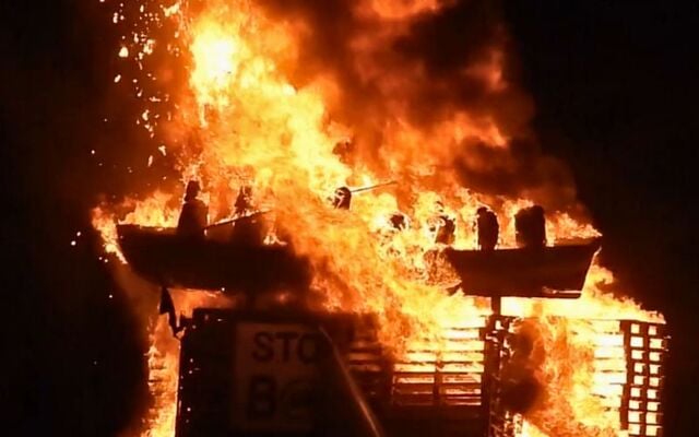 July 10, 2025: The Moygashel bonfire in Co Tyrone - with the Irish flag and migrant effigies on top - on fire.