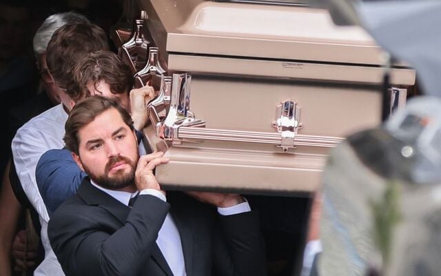 Nicholas DiRubio, the partner of Martha Nolan O’Slatarra, 33, carries her coffin to the hearse at the Cathedral of the Assumption in Carlow.