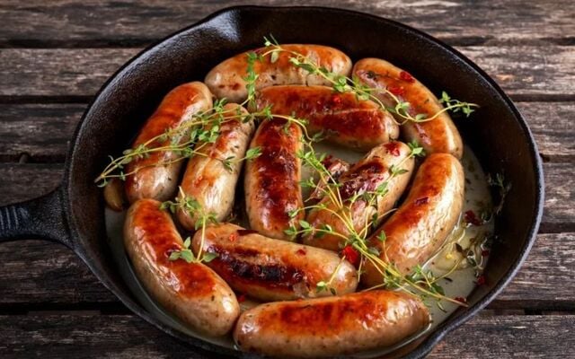 Cider-braised sausages with pickled red onions.