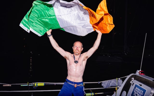 Daragh MacLoughlin holds up the Irish flag after winning the solo class in the World’s Toughest Row.