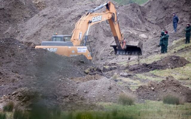 Gardai watch as a digger works to excavate something of interest on the fifth day of work at a quarry site in Co Wicklow near the Kildare border. Investigators are searching for Jo Jo Dullard and Deirdre Jacob, who went missing in 1995 and 1998 respectively.