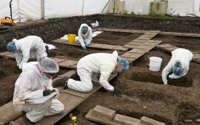 ODAIT forensic staff working under the tented enclosure.