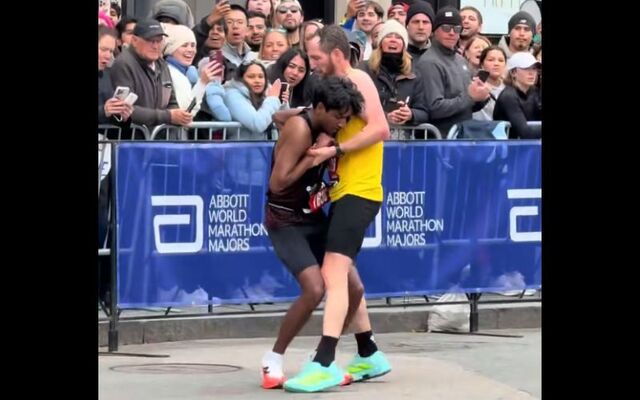 Aaron Beggs stops to help Ajay Haridasse during the final stretch of the 2026 Boston Marathon.