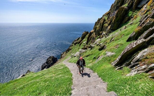 A visitor ascending the stone steps on Skellig Michael Island, in County Kerry.