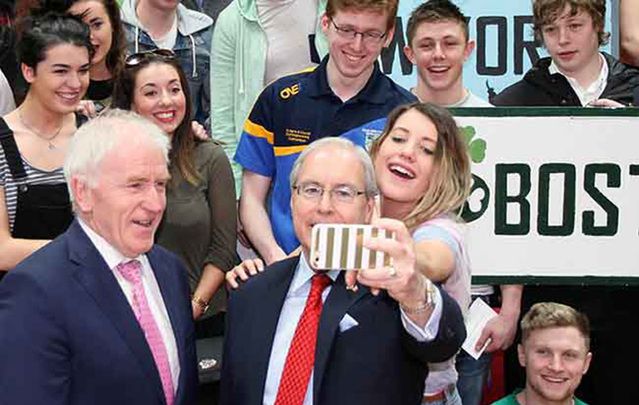 Ireland’s Minister for the Diaspora Jimmy Deenihan and the US Ambassador to Ireland Kevin O’Malley take a self with this year\'s J-1 students at UCD.
