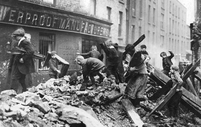 Poor children of Dublin collecting firewood from the ruined buildings damaged in the Easter Rising.