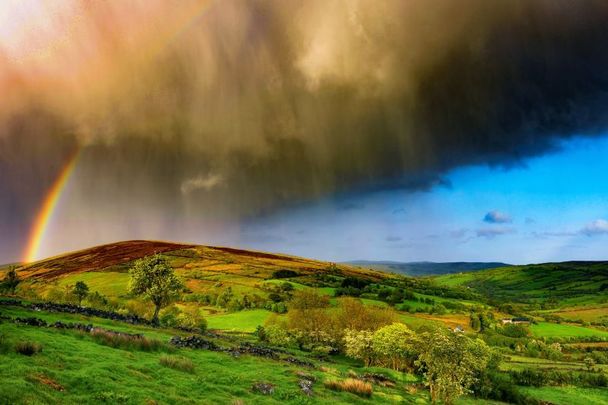Rain clouds and a rainbow over Glenelly Valley in County Tyrone.