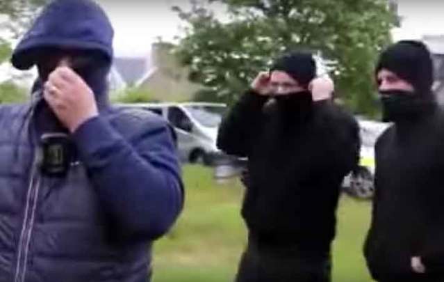 Unidentified men wearing balaclavas arrive at the eviction of a man from his home in Corofin, Co. Clare.