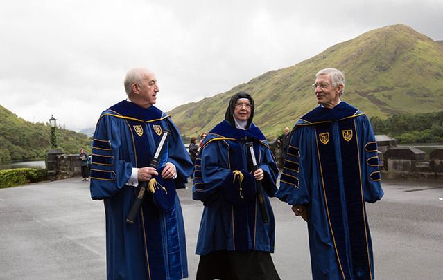President of the High Court of Ireland, Justice Peter Kelly and Mother Abbess Máire Hickey walking with Notre Dame’s Provost, Thomas Burish,.