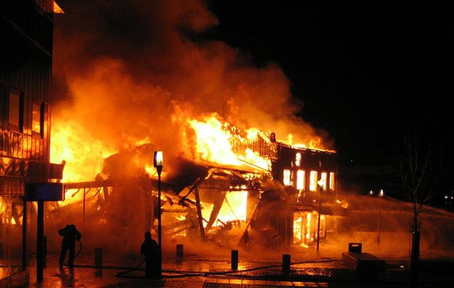 Stock photo of a house fire. Irishman Timothy Brosnan, going through a divorce, allegedly called officers “a buzzkill” for not letting him watch the house burn.