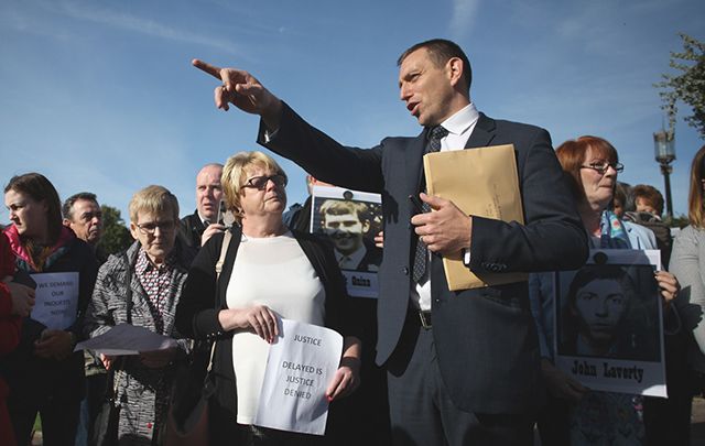 Solicitor Padraig Ó Muirigh with members of the bereaved families outside Stormont today.