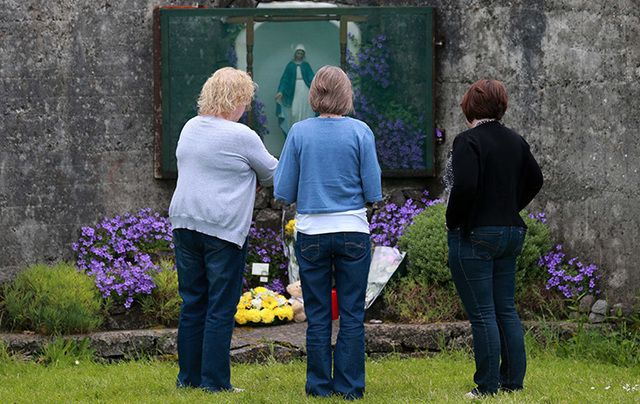 Women pay their respects at the grotto by the site of where 796 children from the Bon Secour Mother and Child home are believed to be buried.