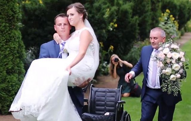 Stuart Patterson, carrying his bride, Hannah up the aisle just weeks after she broke her pelvis in a car crash.
