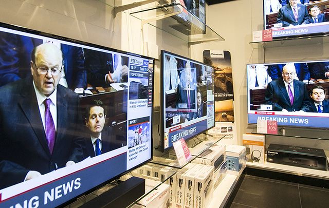 Finance Minister Michael Noonan on TV screens in Arnotts department store in Dublin delivering the budget on Tuesday.