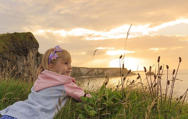 A little girl enjoying the view along the Antrim Coastal Drive.