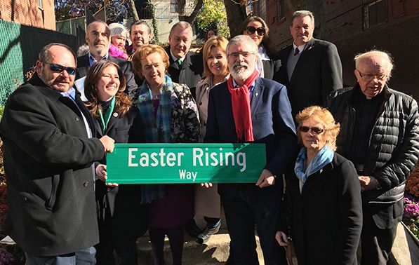 Local dignitaries and Irish figures gather for a photo with the renamed street sign
