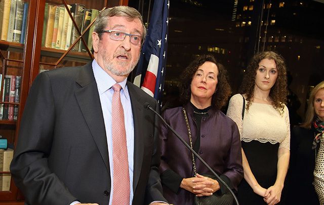 Michael Dowling speaks as guests including his wife Kathleen and daughter Elizabeth, Consul General Barbara Jones and Tommy Smyth look on.