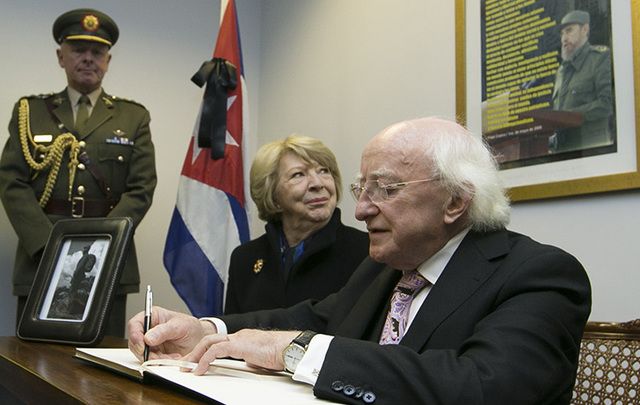 Michael D. Higgins and his wife Sabina sign a book of condolence for Fidel Castro at the Cuban Embassy in Dublin on Monday.
