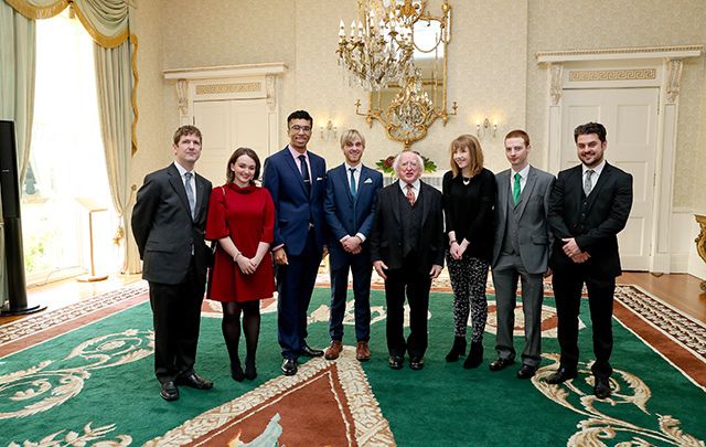 The seven volunteers who contributed to the Irish Duolingo course with Irish President Michael D. Higgins.