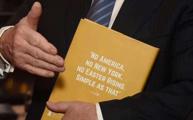 Taoiseach Enda Kenny holds on tightly to his copy of Ireland\'s Allies at the New York Consulate on 2 December 2016. 