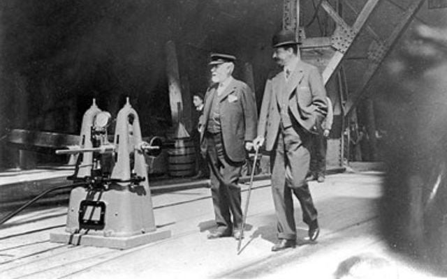 May 31, 1911: J. Bruce Ismay and William Pirrie inspecting RMS Titanic before its launch. Photograph taken by Harland & Wolff shipyard official photographer, Robert Welch.