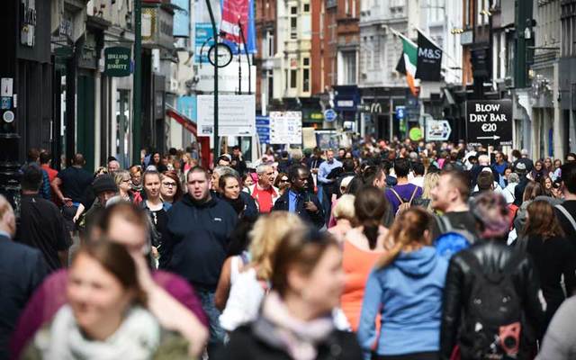 Crowds of people walk on Grafton Street in Dublin.