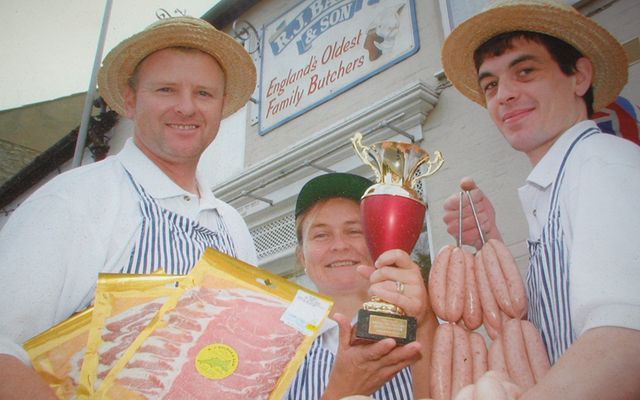 The Balson family pose outside the shop after bringing home the gold.