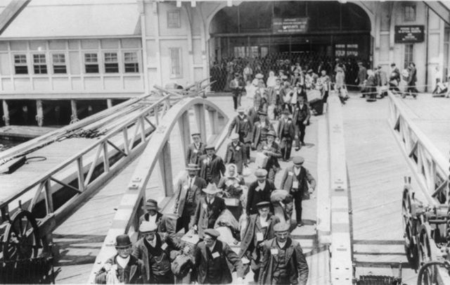 Immigrants arrive to Ellis Island, New York.
