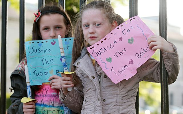 Amy Rose Hyland Holden (left, 10) and her cousin Abbie Conran (9) pictured on the railings at the back of Leinster House in 2014, where a vigil was held to demand justice for the mothers and children who endured cruelty at the hands of the State. 