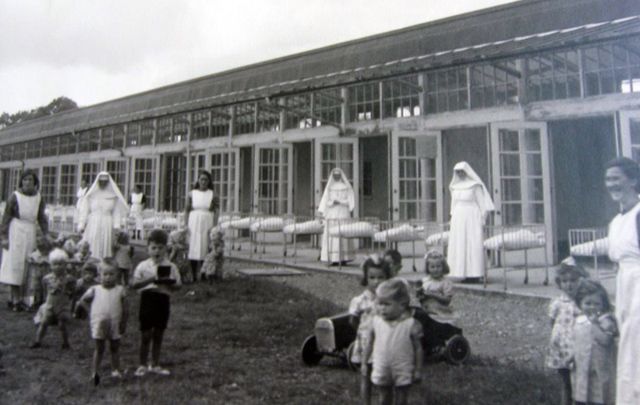 Children taking the area, supervised by nuns, at and Irish Mother and Baby Home. 