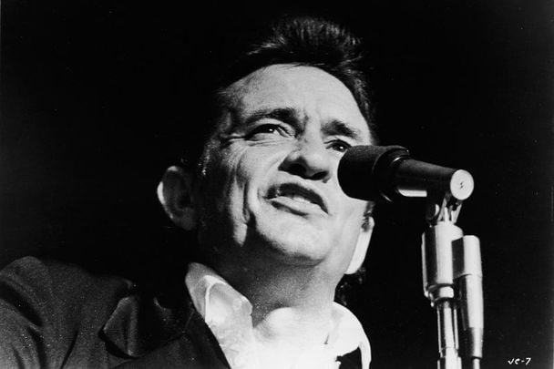 Johnny Cash (1932 - 2003) singing on stage in a still from the film, \"Johnny Cash - The Man, His World, His Music,\" directed by Robert Elfstrom, 1969.