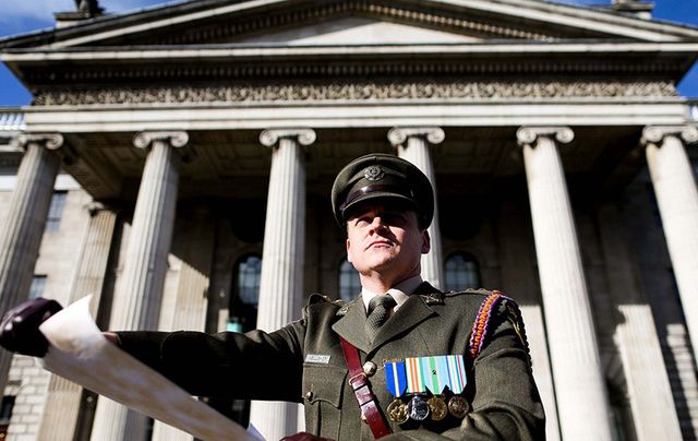 An actor reads a copy of the Proclamation of Independence outside the GPO in 2016.