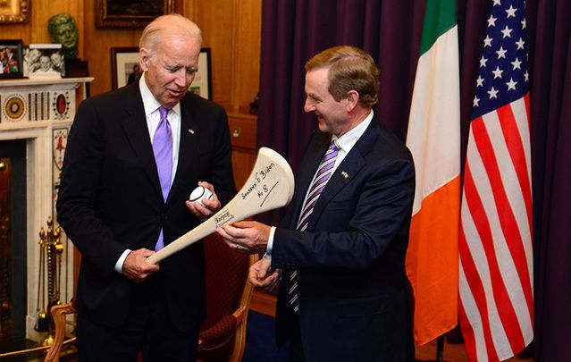 Joe Biden is gifted a hurl and sliotar by the Irish leader Enda Kenny.