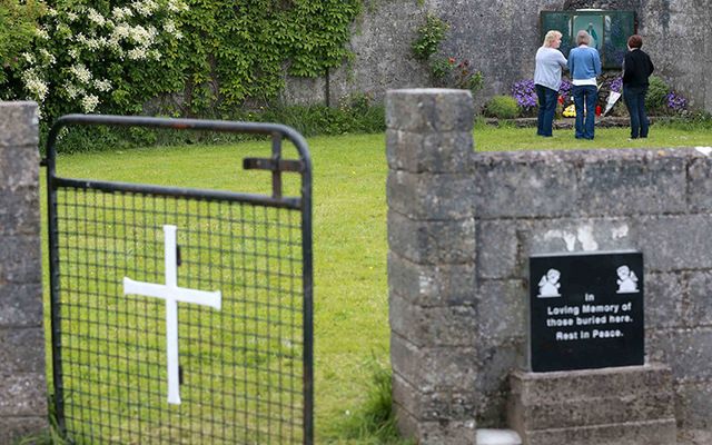 Members of the public pay their respects at the grounds where the unmarked mass grave containing the remains of nearly 800 infants who died at the Bon Secours mother-and-baby home in Tuam, Co. Galway.