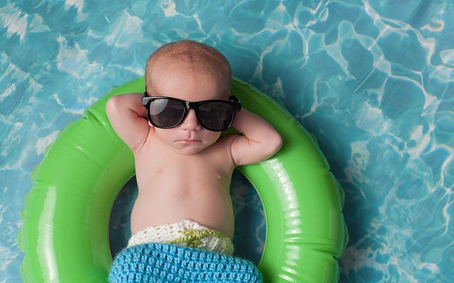 Baby in sunglasses on a float.